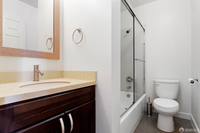 full bathroom featuring vanity, combined bath / shower with glass door, toilet, and tile patterned flooring