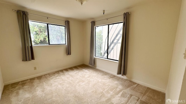 empty room featuring light carpet