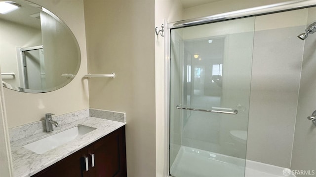 bathroom featuring vanity and walk in shower