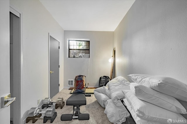 carpeted bedroom featuring visible vents