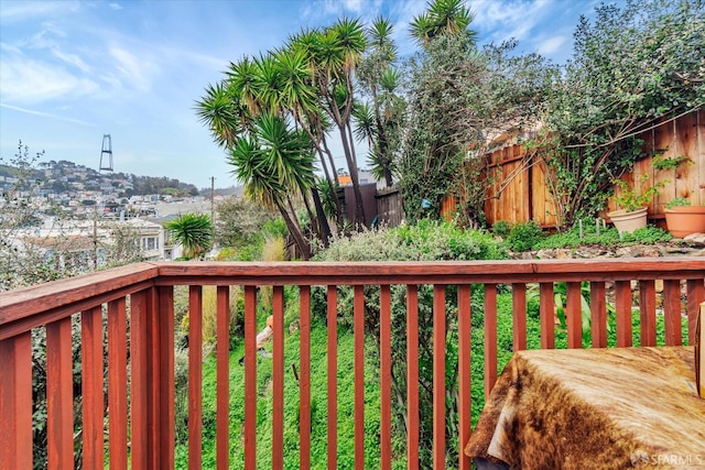 wooden terrace featuring fence