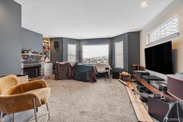 carpeted living room with a brick fireplace and recessed lighting