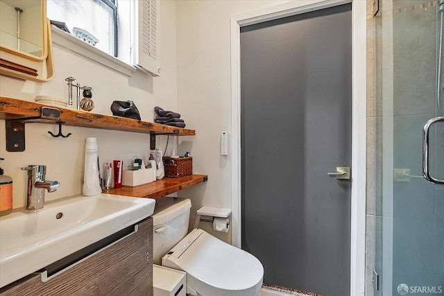 bathroom featuring vanity, a shower stall, and toilet