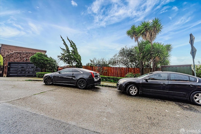 view of car parking featuring fence