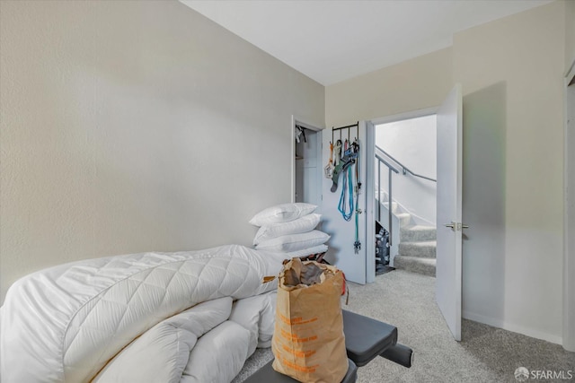 bedroom featuring light carpet and baseboards