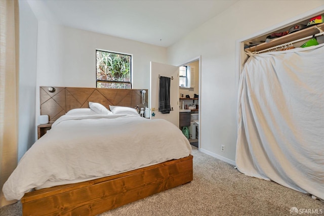 bedroom with light carpet and baseboards