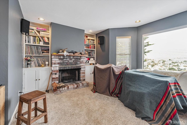 living room featuring recessed lighting, a fireplace, built in features, and light colored carpet