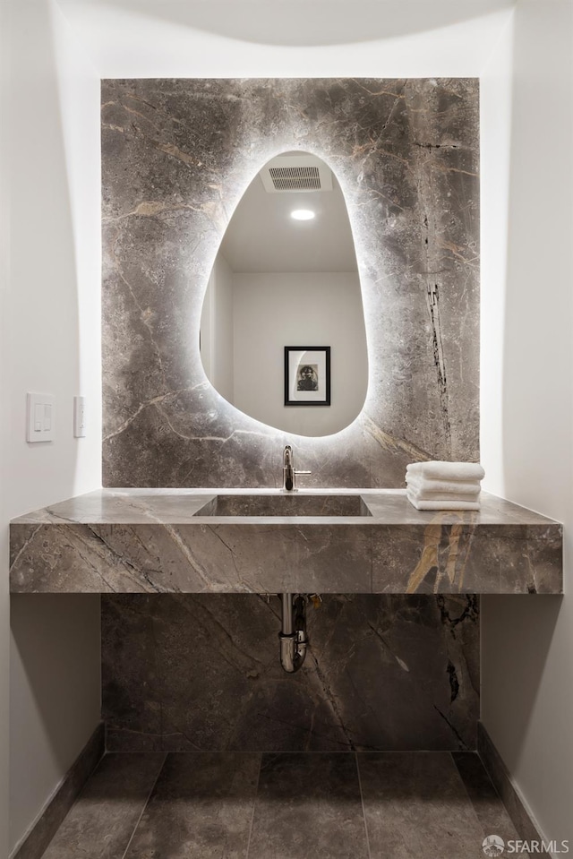 bathroom featuring visible vents and a sink