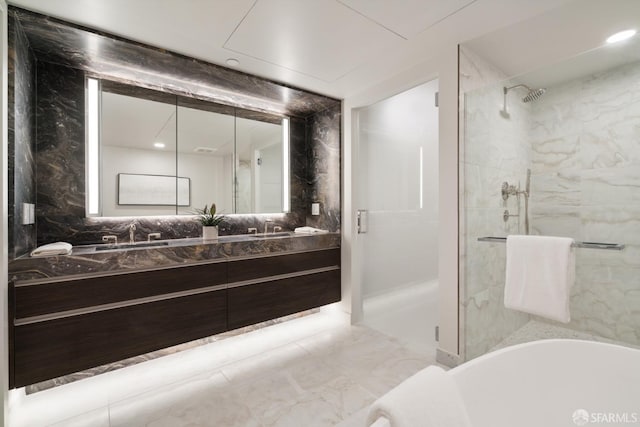 bathroom featuring a tub to relax in, double vanity, a shower stall, a sink, and recessed lighting