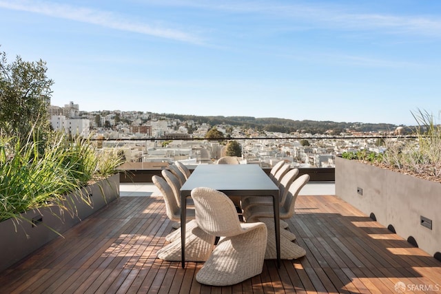 wooden terrace with outdoor dining space