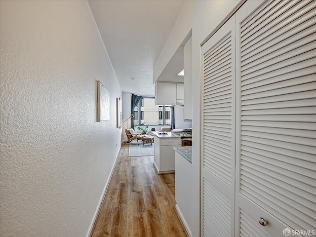 hallway with light wood-type flooring