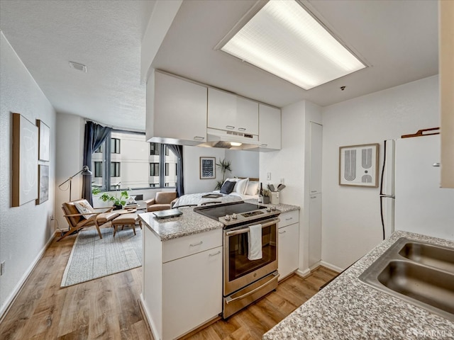 kitchen featuring light hardwood / wood-style floors, white cabinetry, stainless steel electric range oven, and white refrigerator