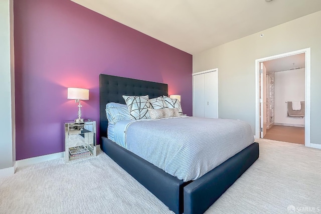 bedroom with carpet, ensuite bath, and a closet