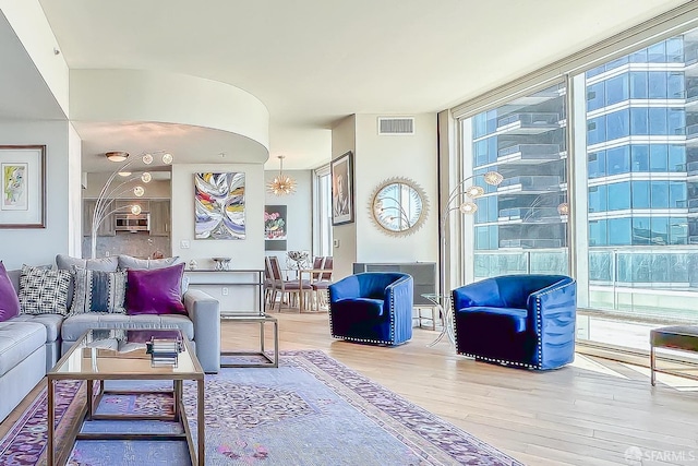 living room featuring wood-type flooring and floor to ceiling windows