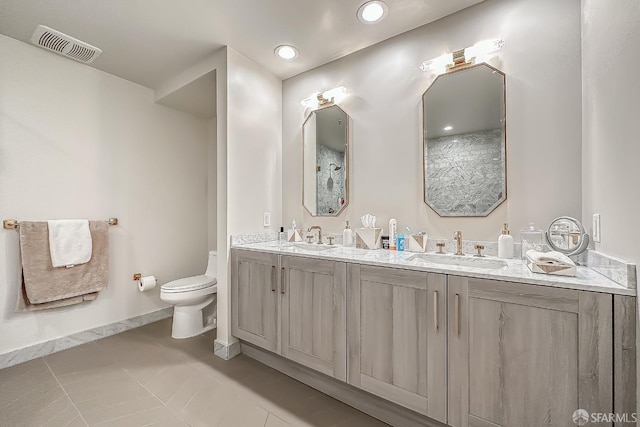 bathroom with vanity, toilet, and tile patterned flooring