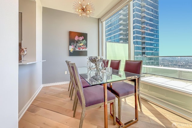 dining area featuring a chandelier and light hardwood / wood-style flooring