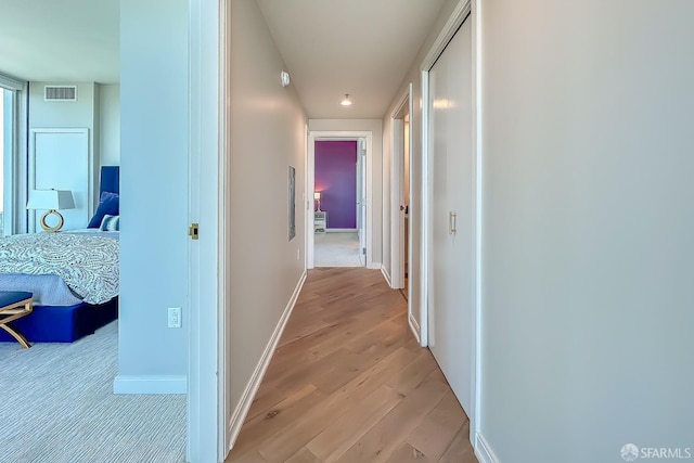 hall with light wood-type flooring