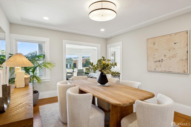 dining space with recessed lighting, baseboards, and wood finished floors