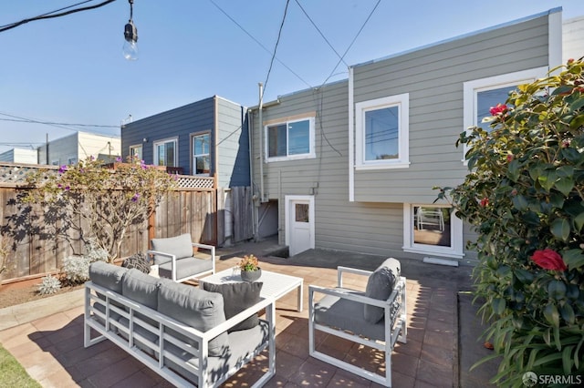 view of patio featuring fence and an outdoor hangout area