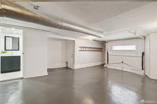 garage featuring baseboards and a sink