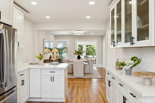 kitchen with recessed lighting, white cabinetry, open floor plan, light countertops, and freestanding refrigerator