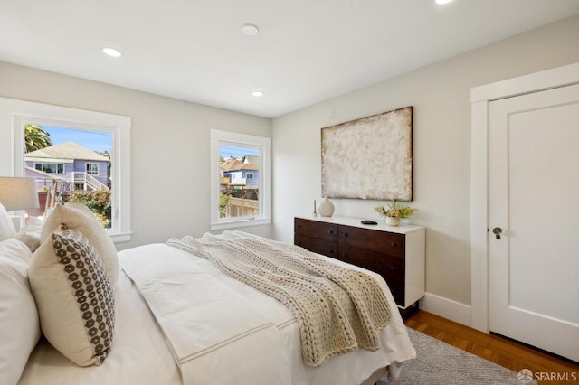 bedroom with multiple windows, baseboards, and recessed lighting