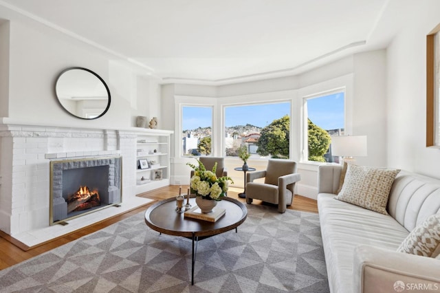 living room with a fireplace and wood finished floors