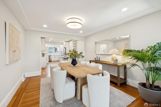 dining space with recessed lighting, light wood-type flooring, visible vents, and baseboards