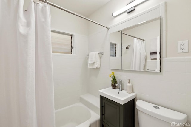 full bath featuring shower / bathtub combination with curtain, tile walls, toilet, and vanity