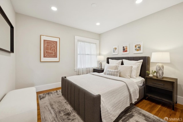 bedroom featuring recessed lighting, wood finished floors, and baseboards