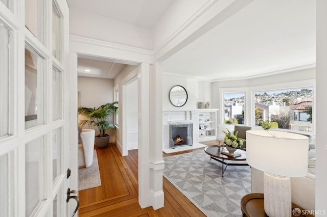 living area featuring a brick fireplace and wood finished floors