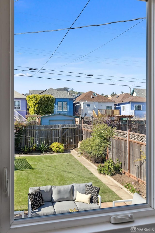 view of yard featuring a residential view, fence, and an outdoor hangout area