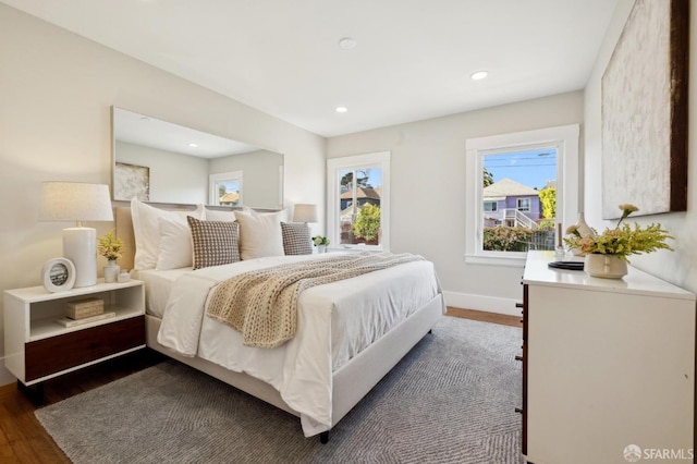 bedroom with dark wood-type flooring, recessed lighting, and baseboards