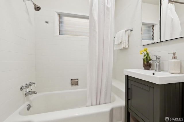 full bath featuring shower / bath combo with shower curtain, backsplash, and vanity