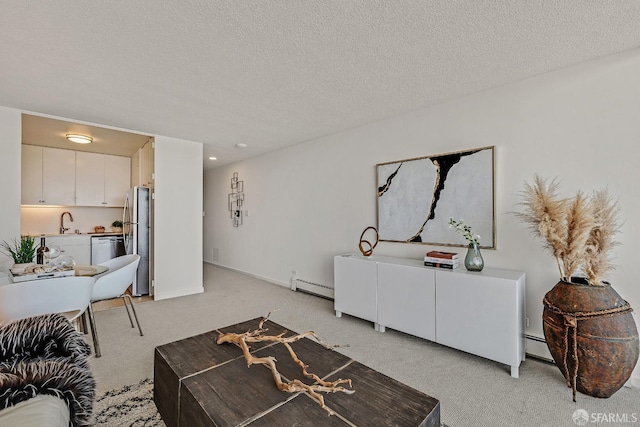 living area with a baseboard heating unit, a textured ceiling, baseboards, and light colored carpet