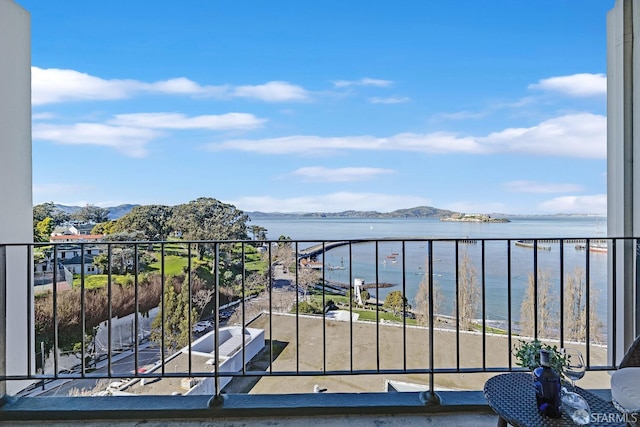 balcony featuring a water and mountain view