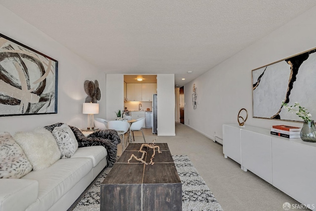 living area with a textured ceiling, a baseboard radiator, and light colored carpet