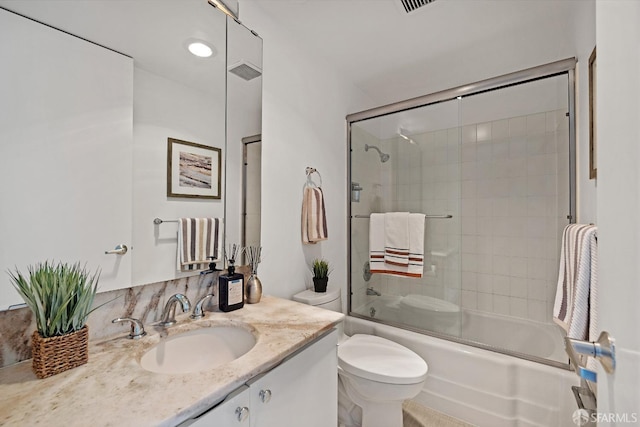 bathroom featuring toilet, enclosed tub / shower combo, visible vents, and vanity