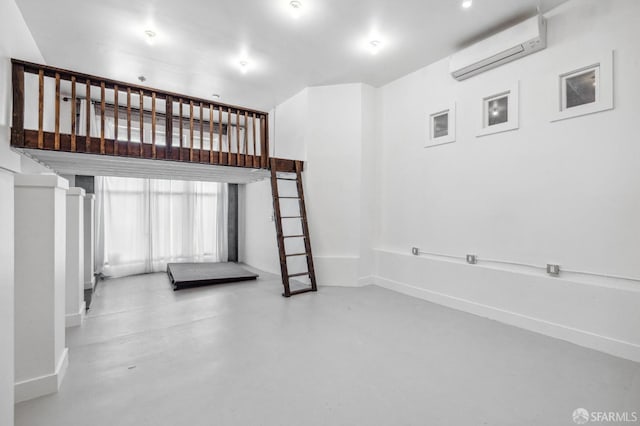 staircase with concrete floors and a wall unit AC