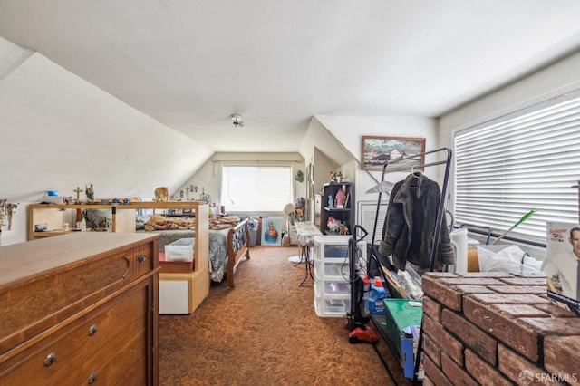 bedroom featuring dark carpet and lofted ceiling