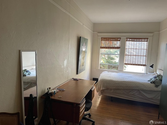 bedroom featuring dark hardwood / wood-style flooring