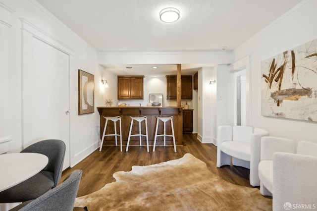 dining room featuring dark wood-type flooring and ornamental molding