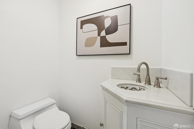 bathroom featuring vanity and toilet