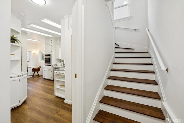 stairs featuring hardwood / wood-style floors