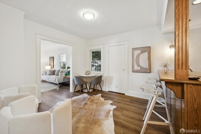 living room featuring ornamental molding and dark hardwood / wood-style floors