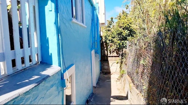 view of home's exterior with fence