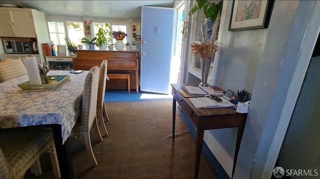 dining room featuring dark colored carpet