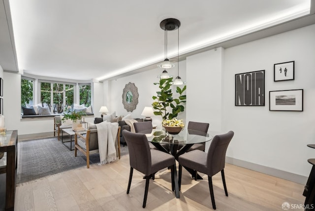 dining space with light wood-type flooring