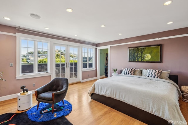 bedroom featuring wood finished floors, recessed lighting, french doors, baseboards, and access to exterior