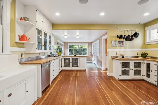 kitchen featuring glass insert cabinets, dishwasher, butcher block counters, white cabinets, and open shelves